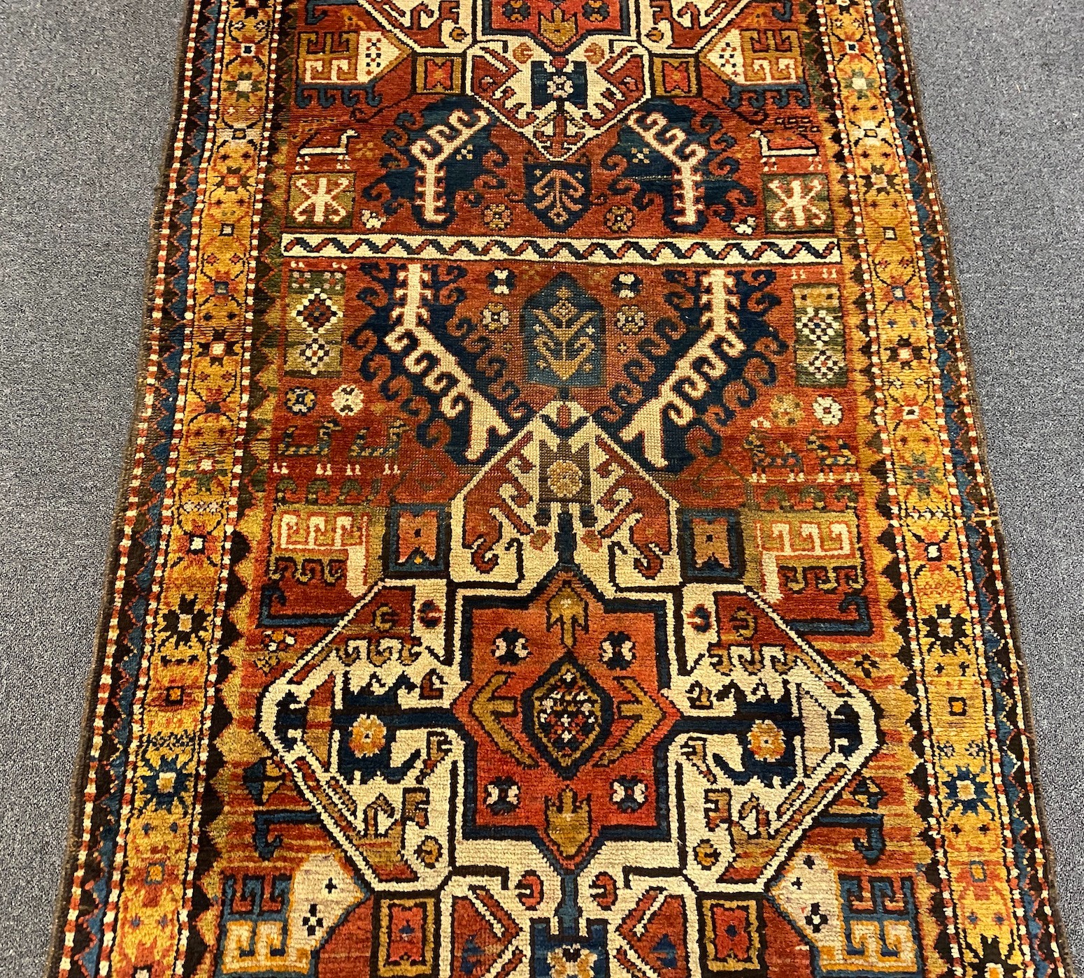 A Kazak red ground rug, 240 x 108cm